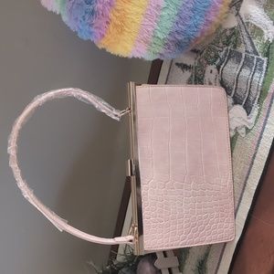 Classy pink clutch with gold accents and detachable long strap